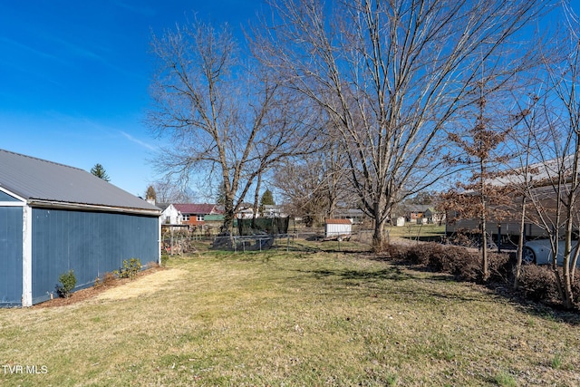 view of yard with an outbuilding and fence