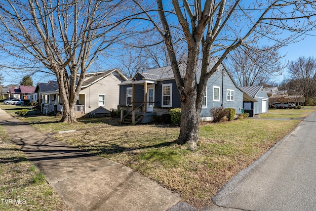 view of front of home featuring a residential view, metal roof, and a front yard