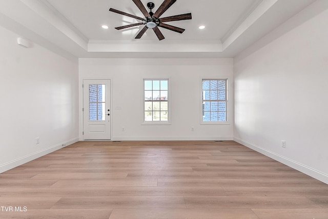 foyer entrance with baseboards, a ceiling fan, light wood-style flooring, a tray ceiling, and recessed lighting