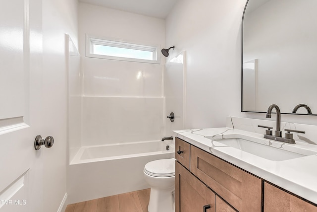 full bathroom featuring toilet, vanity, wood finished floors, and shower / bathtub combination