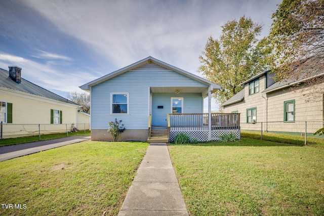 bungalow-style house with a front lawn, a porch, and fence