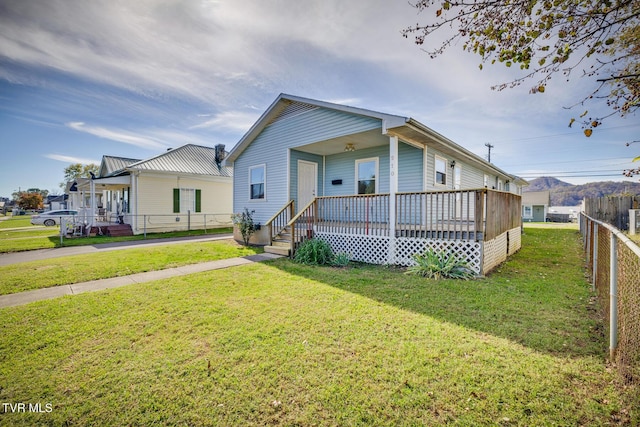 rear view of property with a yard and fence