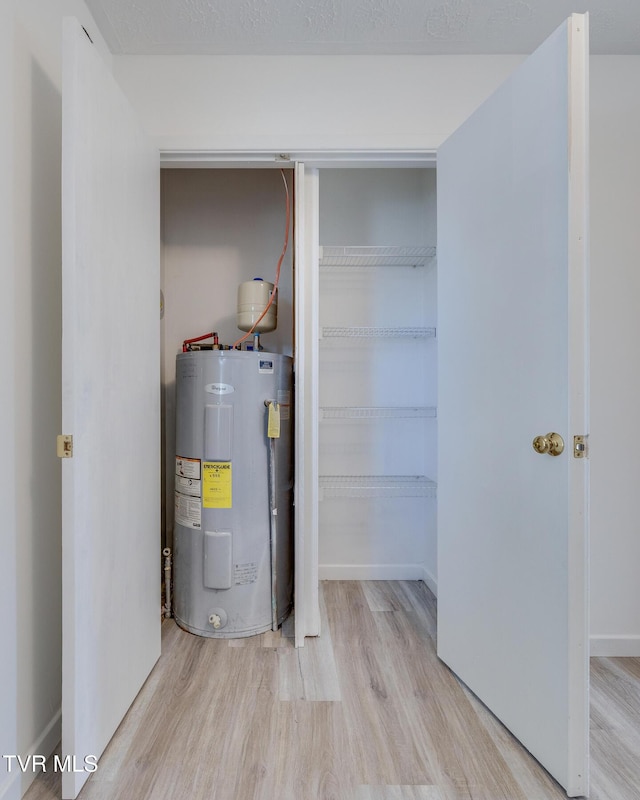 utility room featuring water heater