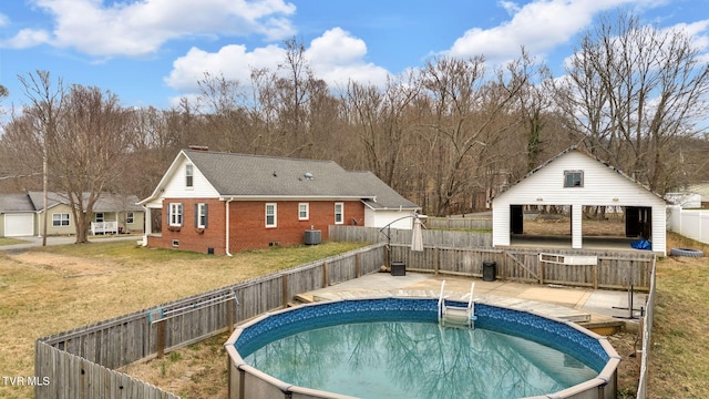 view of swimming pool with a gazebo, central AC unit, a lawn, and a fenced backyard