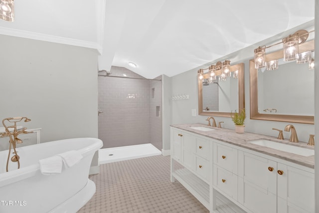 bathroom featuring double vanity, a soaking tub, tiled shower, and a sink