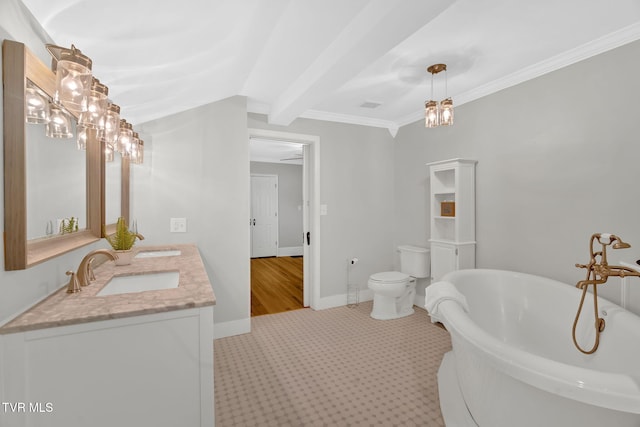 full bathroom with baseboards, double vanity, a freestanding bath, a sink, and crown molding