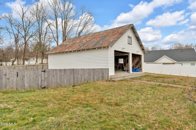 view of outbuilding featuring an outbuilding and fence