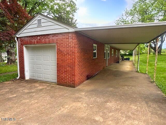 804 E Maple St, Johnson City, TN 37601 - view of side of home featuring driveway, a garage, brick siding, and a carport