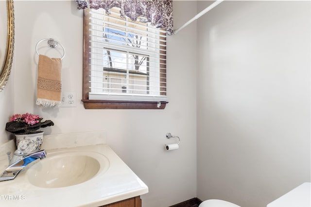 half bathroom featuring toilet and vanity