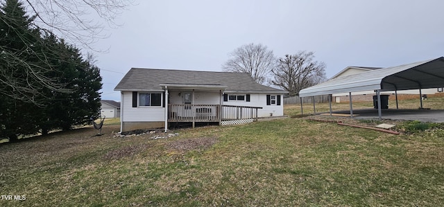 back of property featuring a carport and a lawn