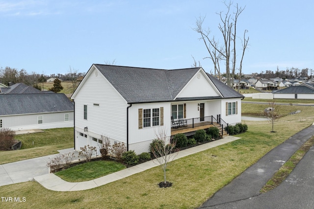 view of front facade featuring a garage, a shingled roof, concrete driveway, covered porch, and a front lawn