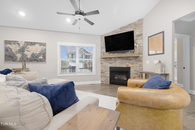 living room with baseboards, a ceiling fan, lofted ceiling, wood finished floors, and a fireplace