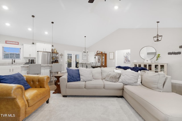 living room featuring a ceiling fan, recessed lighting, and vaulted ceiling