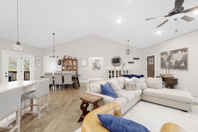 living room with recessed lighting, a ceiling fan, baseboards, vaulted ceiling, and light wood finished floors