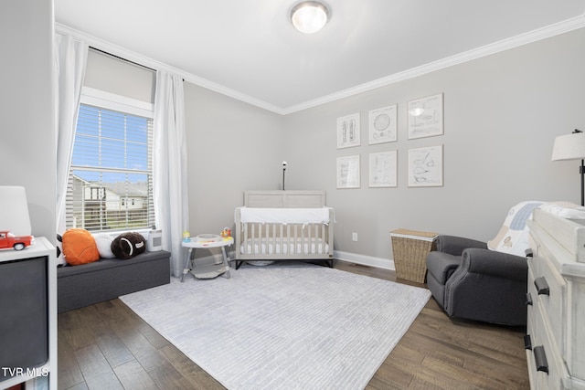 bedroom with baseboards, dark wood finished floors, and crown molding