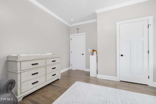 bedroom featuring crown molding, baseboards, and wood finished floors