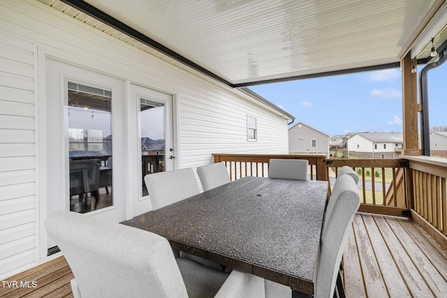 deck featuring a residential view and outdoor dining area