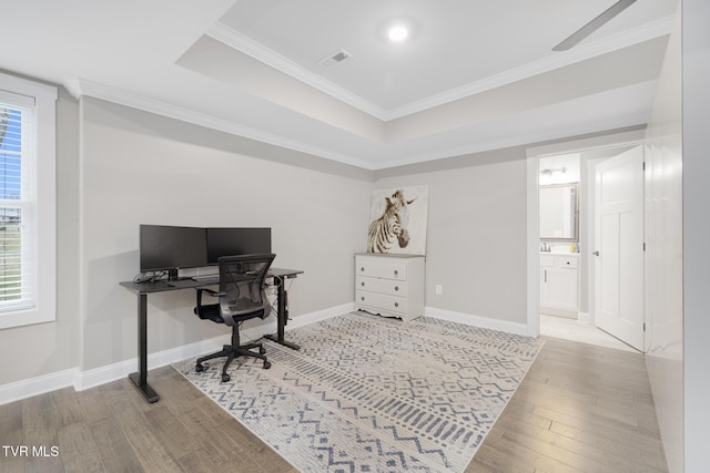 office area with a healthy amount of sunlight, baseboards, visible vents, and hardwood / wood-style floors