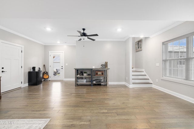 interior space featuring baseboards, ornamental molding, wood finished floors, and recessed lighting