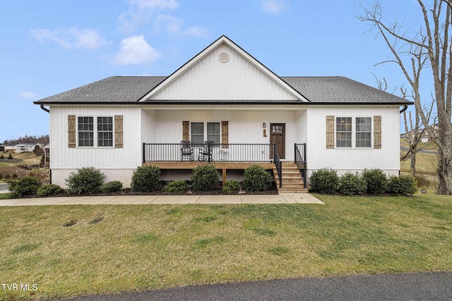 view of front of property featuring a porch, a front yard, and roof with shingles