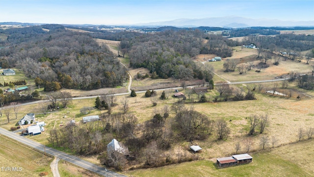 aerial view with a rural view, a mountain view, and a view of trees