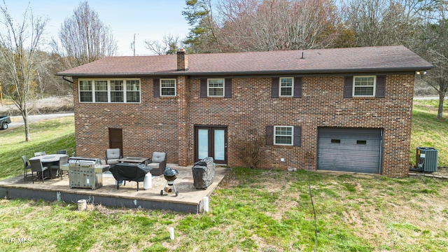 rear view of house featuring a yard, a patio, and brick siding