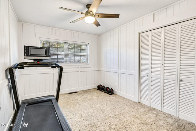 exercise area with carpet floors, visible vents, and a ceiling fan