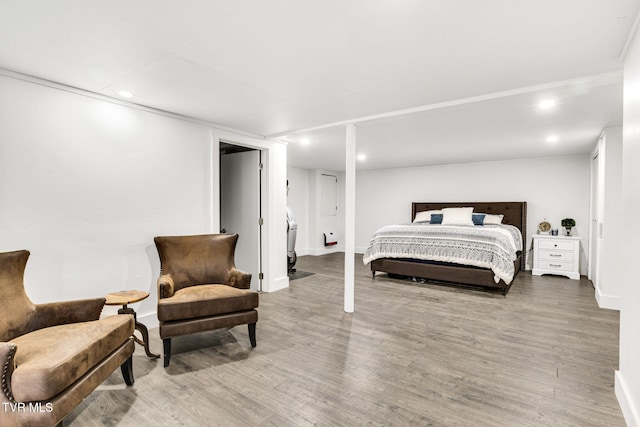 bedroom with recessed lighting, baseboards, and wood finished floors