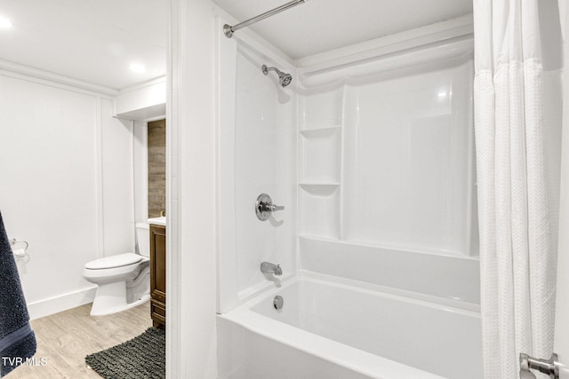 bathroom featuring shower / tub combo with curtain, vanity, toilet, and wood finished floors