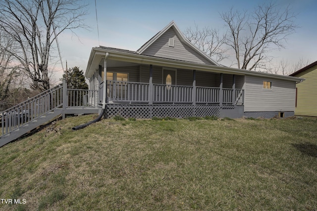 country-style home featuring covered porch and a front yard