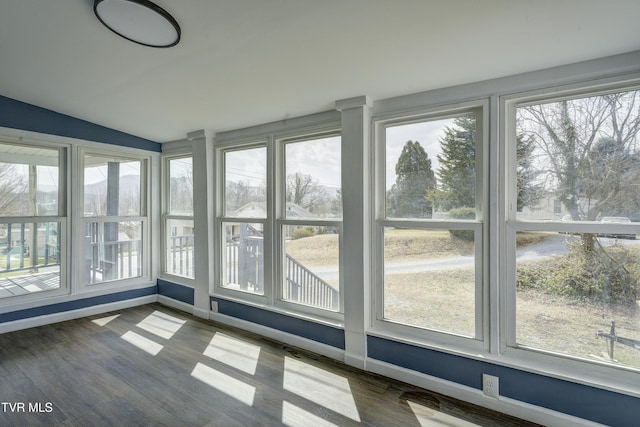 unfurnished sunroom with vaulted ceiling