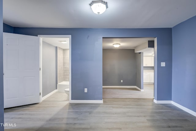 empty room with wood finished floors and baseboards