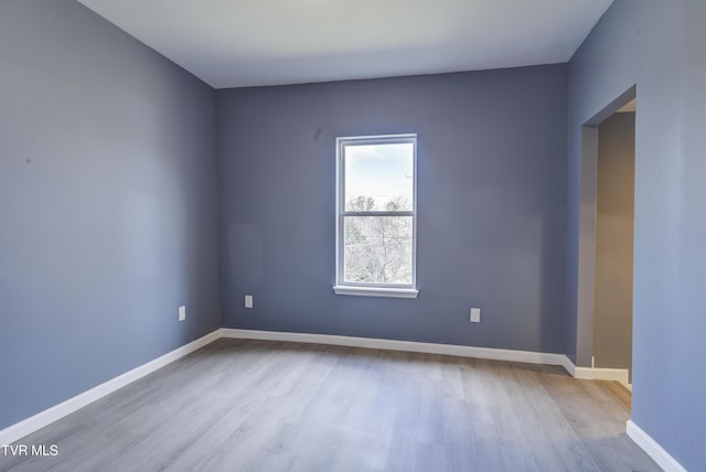 unfurnished room with wood finished floors and baseboards