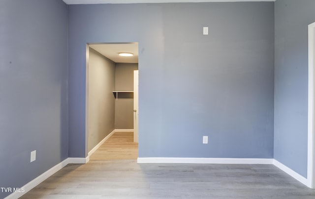 empty room with wood finished floors and baseboards