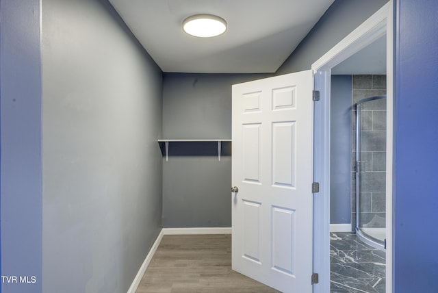 interior space with wood finished floors and baseboards