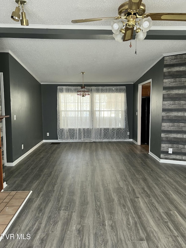 unfurnished living room with lofted ceiling, a textured ceiling, wood finished floors, and crown molding