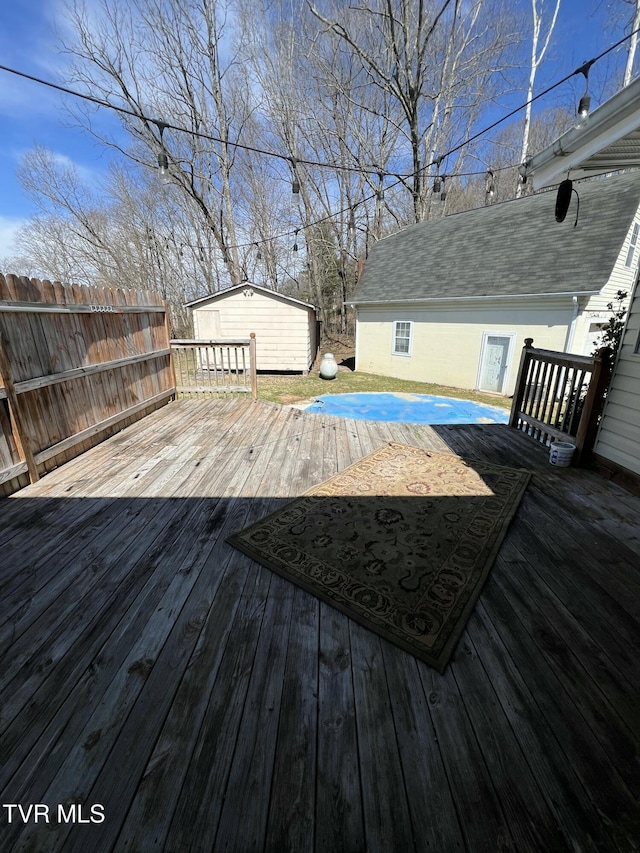 deck with an outdoor structure and fence