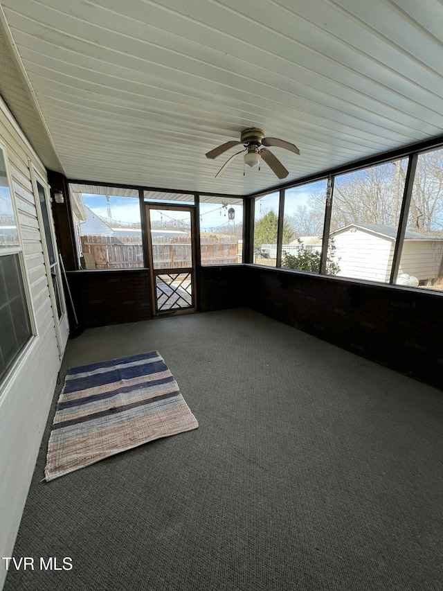 unfurnished sunroom with ceiling fan and a wealth of natural light