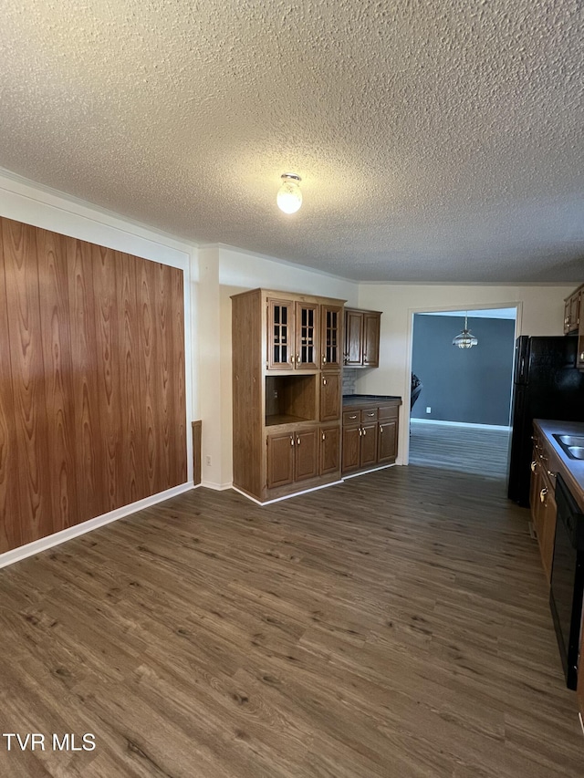 interior space featuring a textured ceiling, baseboards, and dark wood-type flooring