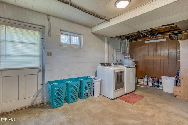 laundry room featuring washer and dryer, laundry area, and concrete block wall