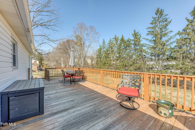 deck featuring outdoor dining area