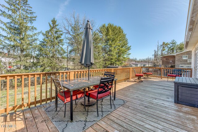 wooden deck featuring outdoor dining area