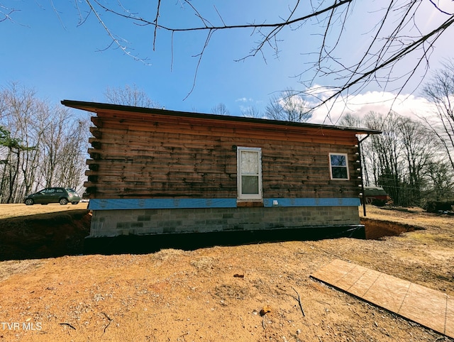 view of side of property featuring log siding