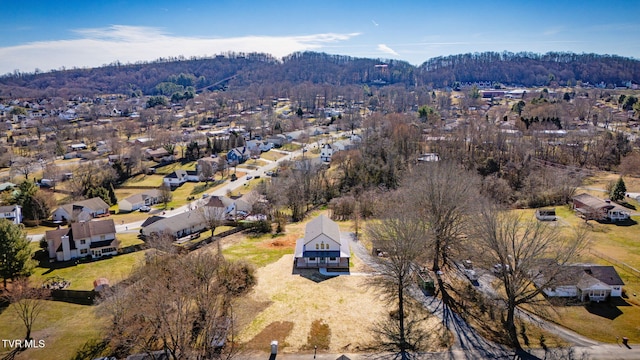 drone / aerial view with a forest view and a residential view