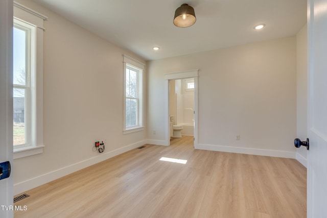 interior space with light wood finished floors, recessed lighting, visible vents, and baseboards