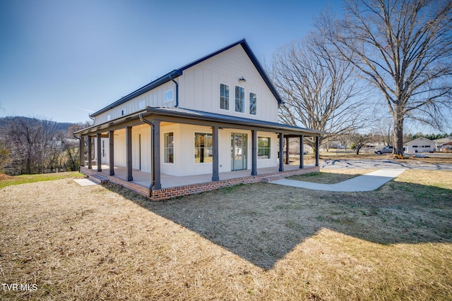 view of front facade featuring board and batten siding, a porch, and a front lawn