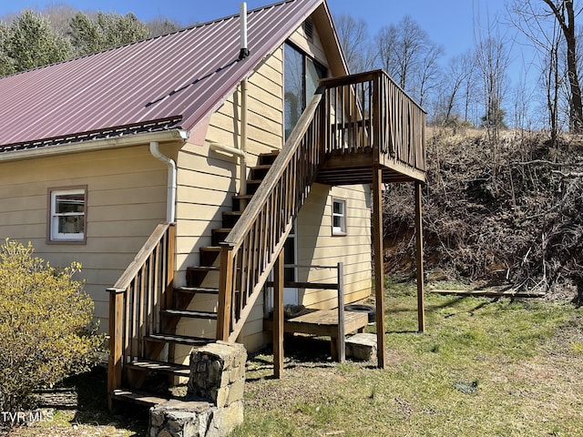 exterior space featuring metal roof and stairs