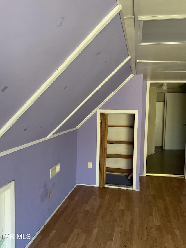 bonus room featuring vaulted ceiling and wood finished floors