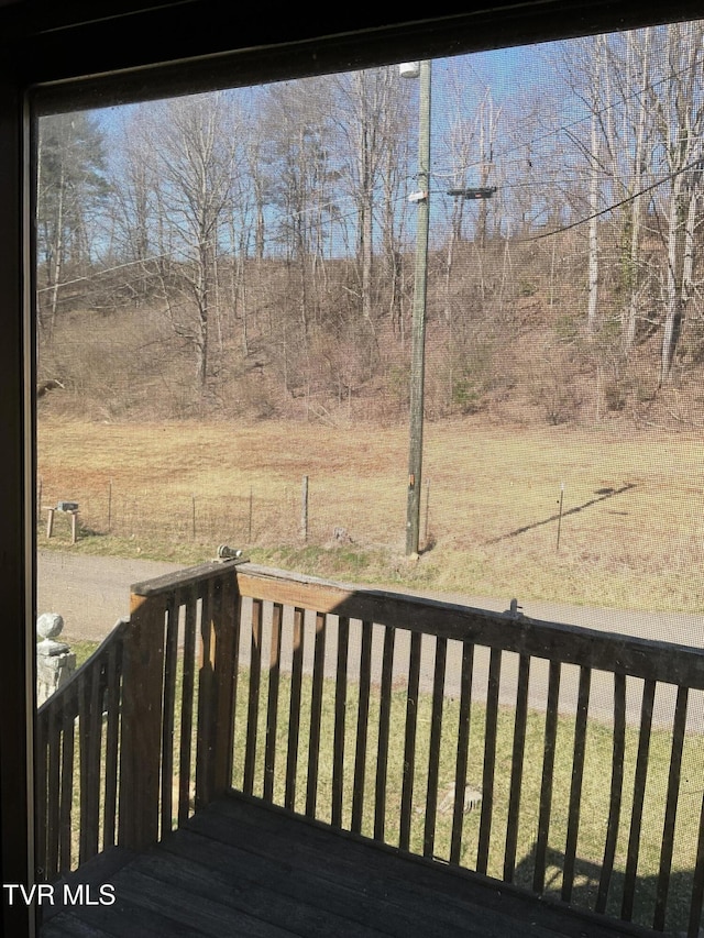 wooden deck featuring a lawn