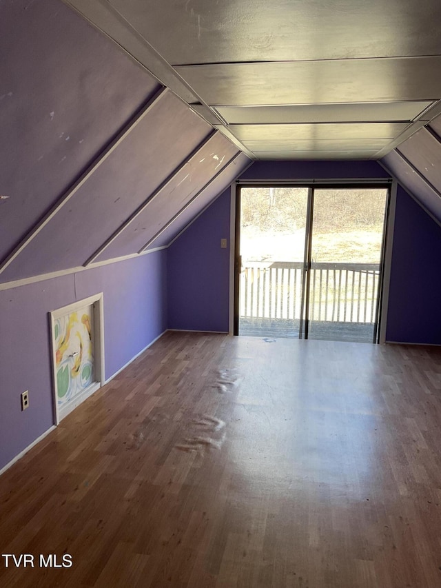 bonus room with lofted ceiling and wood finished floors